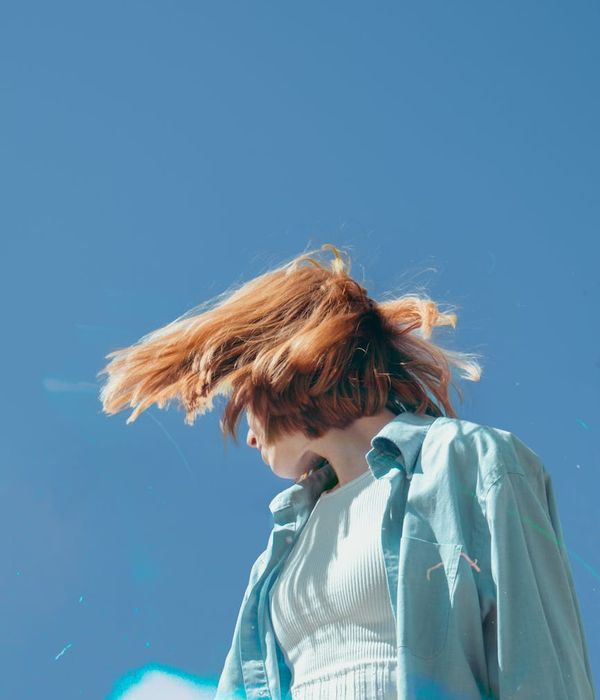 Woman feeling energetic and full of life in a bright, airy space.